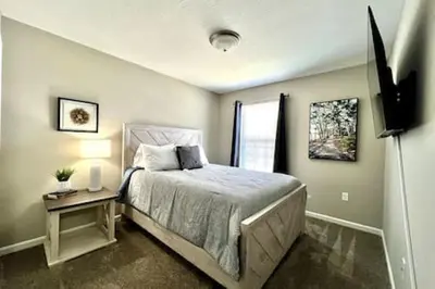 a bedroom with a bed and a television in it at Brand New Home Walking distance to Spooky Nook in Hamilton