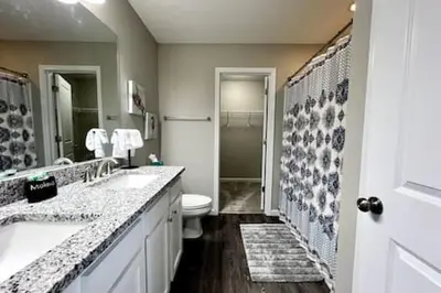 a bathroom with two sinks and a toilet and a mirror at NEW Executive Home in Germantown, OH in Germantown