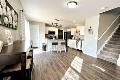 a large living room with a staircase and a kitchen at NEW Executive Home in Germantown, OH in Germantown