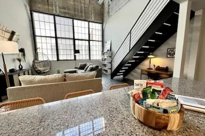 a living room with a table and a couch at 5104 Cartridge Factory Loft in Maineville