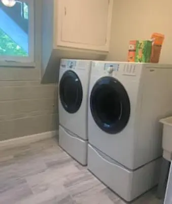 a washer and dryer sitting in a laundry room at Beautiful home Among trees outside the city in Dent