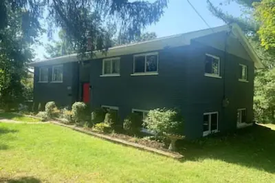 a large house with a yard in front of it at Beautiful home Among trees outside the city in Dent