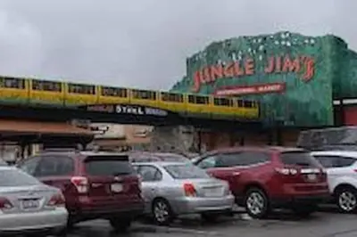 a group of cars parked in a parking lot with a train at Beautiful home Among trees outside the city in Dent