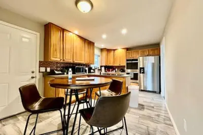 a kitchen with a table and chairs in it at Beautiful home Among trees outside the city in Dent