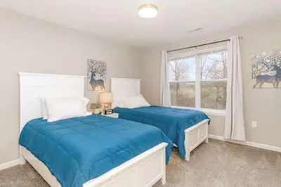 a bedroom with two beds and a window at Quietly nestled home among the Nook in Hamilton