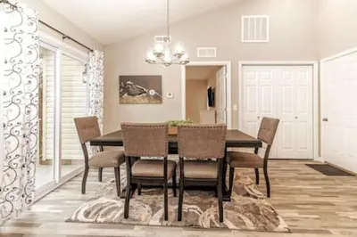 a dining room with a table and chairs at Quietly nestled home among the Nook in Hamilton