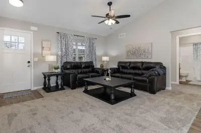 a living room with a couch and a table at BRAND NEW Home away from Home among the Nook in Hamilton