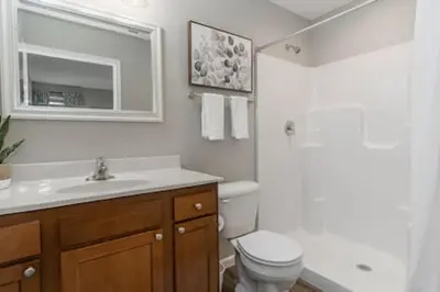 a bathroom with a toilet and a sink and a mirror at BRAND NEW Home away from Home among the Nook in Hamilton