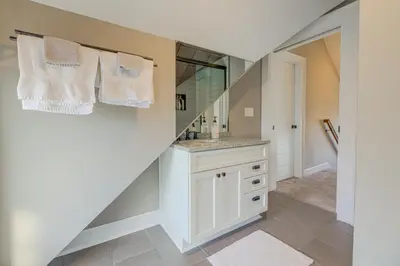 a bathroom with a sink and a mirror at Charming Cincinnati Home with Spacious Deck! in Cincinnati