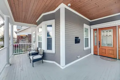 a front porch of a house with a wooden ceiling at Charming Cincinnati Home with Spacious Deck! in Cincinnati