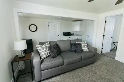 a living room with a couch and a clock on the wall at Great Location in Dayton! Updated 1 bedroom/bath. in Dayton