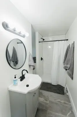 a white bathroom with a sink and a shower at Great Location in Dayton! Updated 1 bedroom/bath. in Dayton