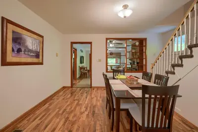 a dining room and living room with a table and chairs at Hillside Hideaway in Logan