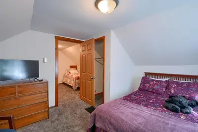 a bedroom with a bed and a flat screen tv at Hillside Hideaway in Logan