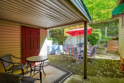 a patio with a table and chairs and an umbrella at Hillside Hideaway in Logan