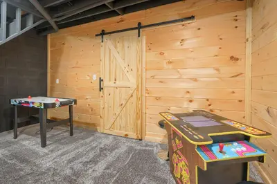 a room with a door and a ping pong table at Hideaway Pines in Logan