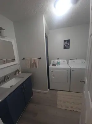 a bathroom with a sink and a washing machine at Hidden Gem close to Athens/Logan in Nelsonville