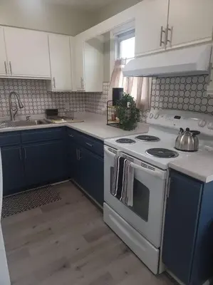a kitchen with a white stove and blue cabinets at Hidden Gem close to Athens/Logan in Nelsonville