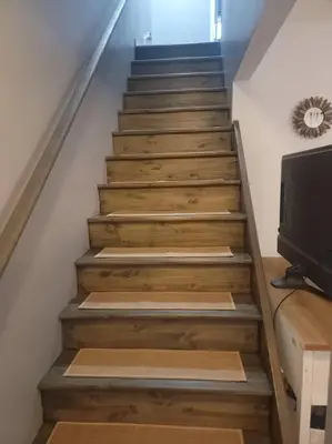 a staircase with wooden steps with a television on it at Hidden Gem close to Athens/Logan in Nelsonville