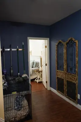 a room with a blue wall and a wooden door at Walkout Basement Near Creation Museum in Hebron