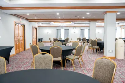 a meeting room with tables and chairs in a room at Coshocton Village Inn & Suites in Coshocton