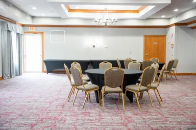 a conference room with a table and chairs at Coshocton Village Inn & Suites in Coshocton
