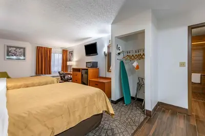 a hotel room with two beds and a desk at Quality Inn Austintown-Youngstown West in Youngstown