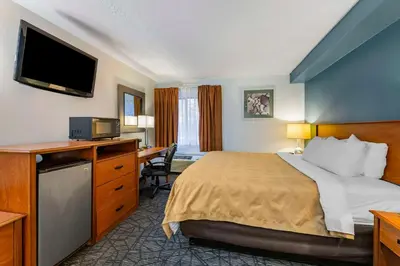 a hotel room with a bed and a desk at Quality Inn Austintown-Youngstown West in Youngstown