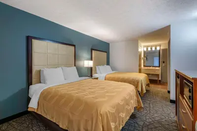 a hotel room with two beds and a television at Quality Inn Austintown-Youngstown West in Youngstown