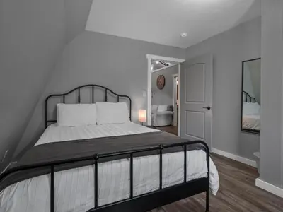 a bedroom with a large bed with white sheets at The Barn at Sharp Run-Modern Barn in the heart of Amish Country in Millersburg