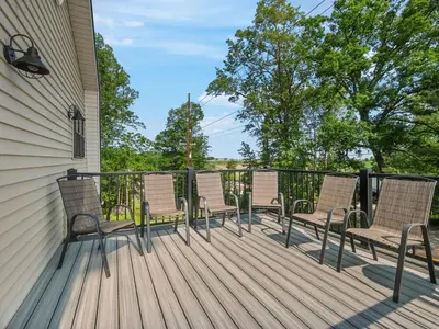 a group of chairs sitting on a deck at The Barn at Sharp Run-Modern Barn in the heart of Amish Country in Millersburg