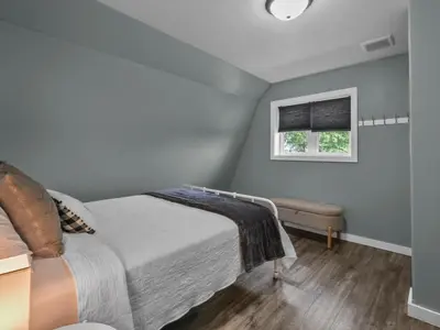 a bedroom with a bed and a window at The Barn at Sharp Run-Modern Barn in the heart of Amish Country in Millersburg