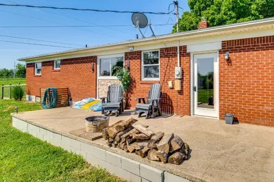 a backyard with two chairs and a fire pit at 7 Mi to Depot District Richmond Home with Fire Pit in Richmond