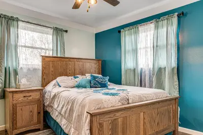 a bedroom with a bed with blue walls at 7 Mi to Depot District Richmond Home with Fire Pit in Richmond