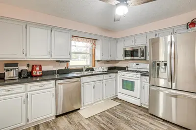 a kitchen with white cabinets and stainless steel appliances at Spacious Delaware Home with Game Room! in Delaware