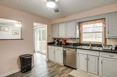 a kitchen with white cabinets and a sink and a window at Spacious Delaware Home with Game Room! in Delaware
