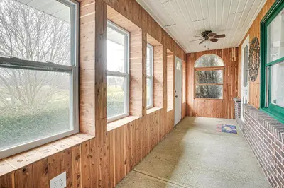 a room with wood paneled walls and windows at Spacious Delaware Home with Game Room! in Delaware