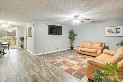 a living room with two couches and a flat screen tv at Spacious Delaware Home with Game Room! in Delaware