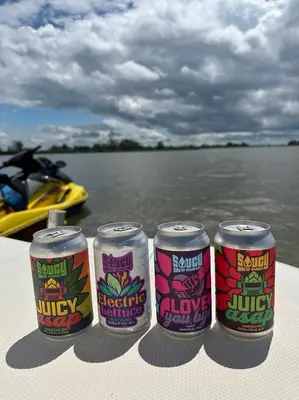 three cans of soda sitting on the side of a boat at Bayshore Resort At Put-In-Bay in Put-in-Bay
