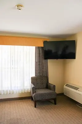 a room with a chair and a flat screen tv at Kelleys Island Venture Resort in Kelleys Island