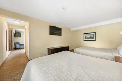 a hotel room with two beds and a television at Kelleys Island Venture Resort in Kelleys Island