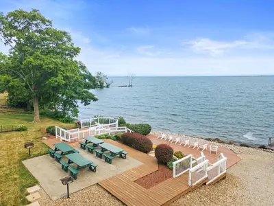 a wooden deck with chairs and a ceremony on the water at Kelleys Island Venture Resort in Kelleys Island