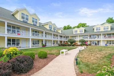 a large apartment building with a walkway at Kelleys Island Venture Resort in Kelleys Island