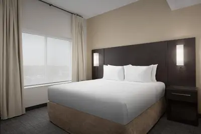 a large white bed in a hotel room with a window at Residence Inn by Marriott Kenwood Cincinnati in Kenwood