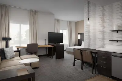 a living room with a couch a table and a tv at Residence Inn by Marriott Kenwood Cincinnati in Kenwood