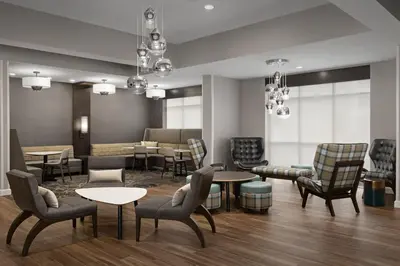 a waiting room with tables and chairs at Residence Inn by Marriott Kenwood Cincinnati in Kenwood