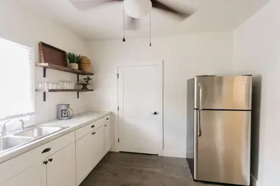 a kitchen with a stainless steel refrigerator and a sink at Beautiful Cape Cod House in Central Location in Dayton
