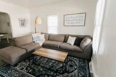 a living room with a couch and a coffee table at Beautiful Cape Cod House in Central Location in Dayton
