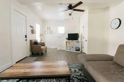 a living room with a couch and a ceiling fan at Beautiful Cape Cod House in Central Location in Dayton