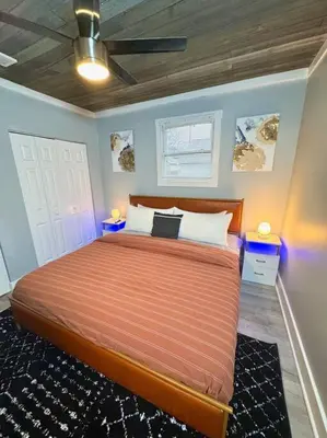 a bedroom with a large bed with blue walls at Little house on 47th in Cleveland